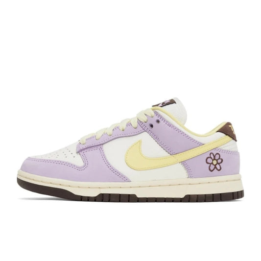 An image of the Nike Dunk Low Purple 'Lilac Flower' showing the yellow Swoosh and the small flower on the heel box.