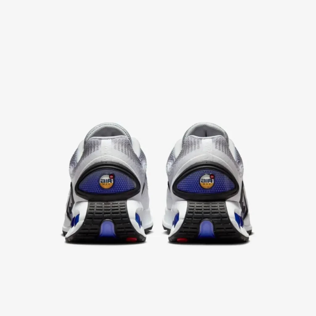 The Nike Air Max Dn "Light Smoke Grey/Persian Violet back view showing two pairs heels.