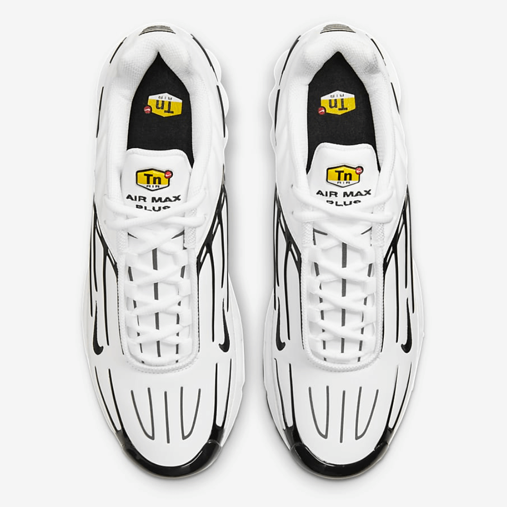 Upper view of the nike air max plus 3 in white and black. this image showcases the shoe's yellow tn logo on the upper tongue.