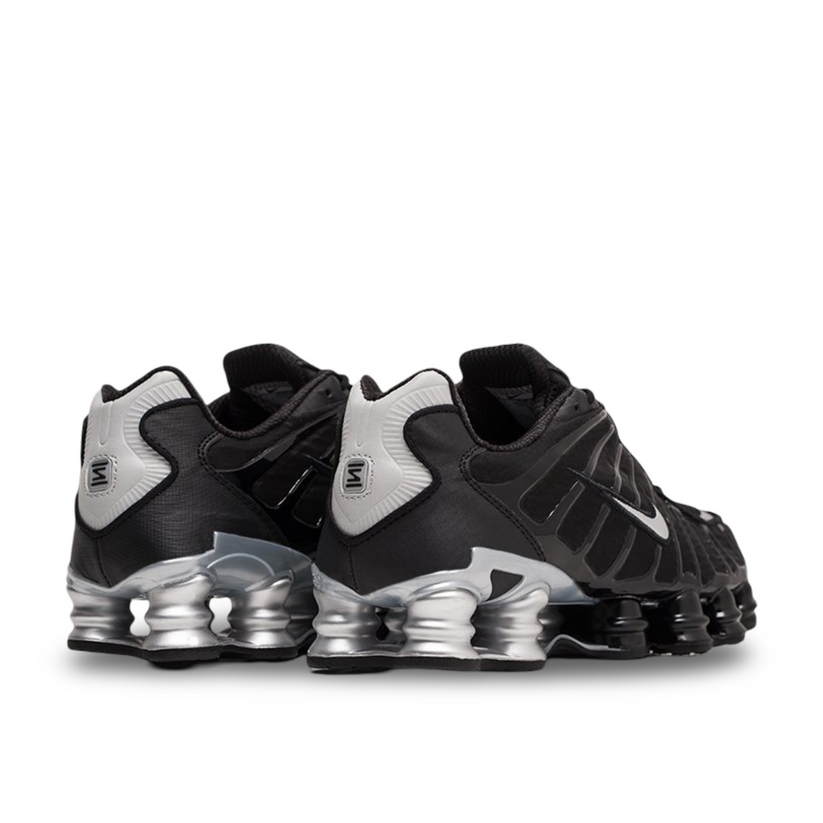 Nike Shox TL Black Silver shoes displayed on a stylish background.