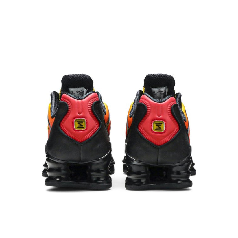 Back view of Nike Shox TL x Skepta showcasing the sleek design and iconic Shox cushioning system in a striking Black/Red colorway.