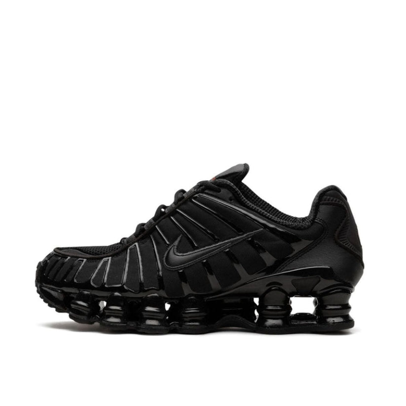 Side angle shot of the Nike Shox TL All Black, emphasizing its modern silhouette and the iconic Shox cushioning system that adds both style and performance.