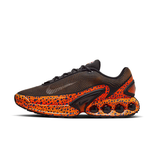 Nike Air Max Dn Safari product main image showing the orange sole with 4 black air dots. The upper has a lower orange and black in spots layer and a black synthetic upper.