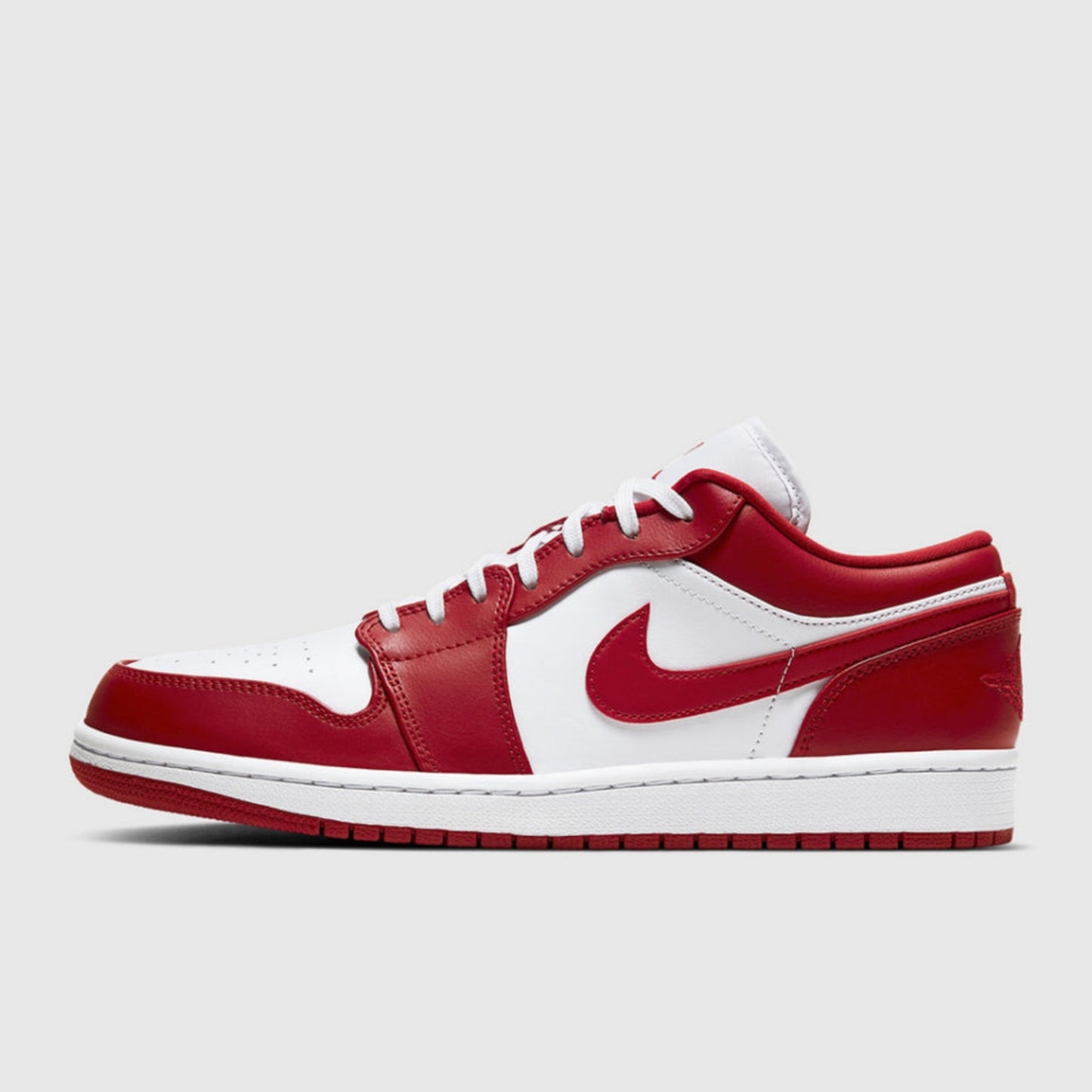 Side view of the Men's Air Jordan 1 Low "New Beginnings" sneaker in Gym Red and White, showcasing its encapsulated Air-Sole unit and durable solid-rubber outsole for maximum comfort and traction.