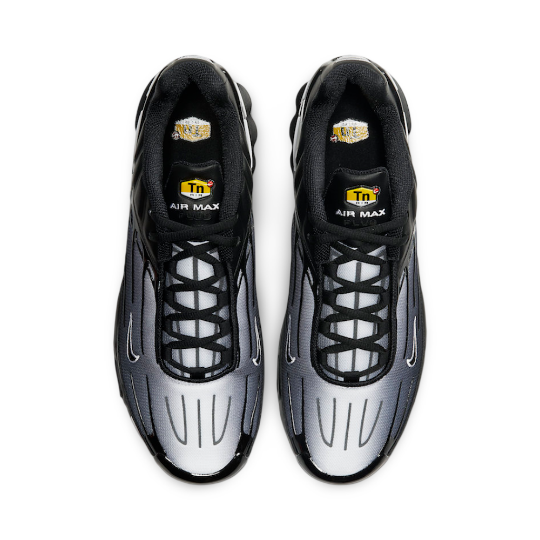 Elevated view of the nike obsidian air max plus 3 shoes. it shows a yellow tn logo on the inner tongue and the upper tongue.